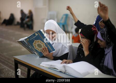 Blind students read the Koran in Braille during class at the 