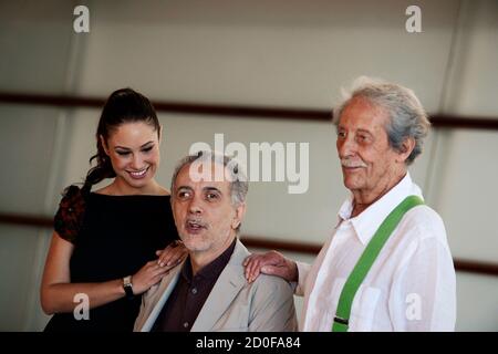 Cast members Aida Folch (L) and Jean Rochefort (R) pose with director Fernando Trueba at a photocall to promote 'El Artista y La Modelo' (The artist and the model) at the Kursaal Centre on the fourth day of the San Sebastian Film Festival September 24, 2012. The film is part of the festival's Official Selection. REUTERS/Vincent West (SPAIN - Tags: ENTERTAINMENT)