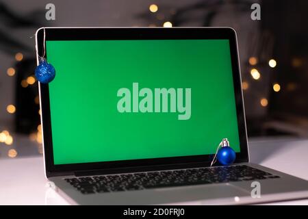 laptop with green screen - chromakey near New Year's decorations. christmas theme. template.  Stock Photo