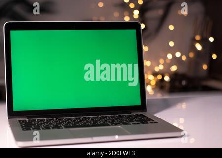 laptop with green screen - chromakey near New Year's decorations. christmas theme. template.  Stock Photo