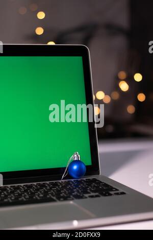 laptop with green screen - chromakey near New Year's decorations. christmas theme. template.  Stock Photo