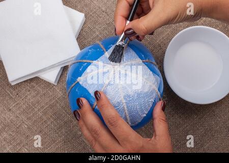 making DIY pumpkin out of napkins and a balloon, a hobby on insulation Stock Photo