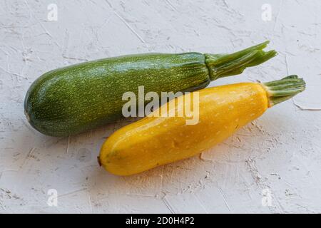 Just picked squashes on white structured background. Just harvested vegetables. Top view. Stock Photo
