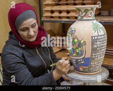 Petra, Jordan - 2019-04-20 - Woman creates intricate mosaic vase. Stock Photo