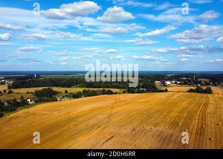 Aerial photo. View of a yellow harvested field in the countryside Stock Photo