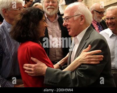 British physicist Peter Higgs (R) congratulates Fabiola Gianotti, ATLAS experiment spokesperson, after her results presentation during a scientific seminar to deliver the latest update in the search for the Higgs boson at the European Organization for Nuclear Research (CERN) in Meyrin near Geneva July 4, 2012. REUTERS/Denis Balibouse (SWITZERLAND - Tags: SCIENCE TECHNOLOGY)