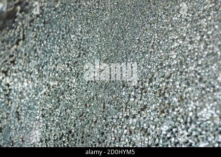 Closeup surface of the car glass cracks caused by an accident on the road leading to the insurance claim in the garage. Stock Photo