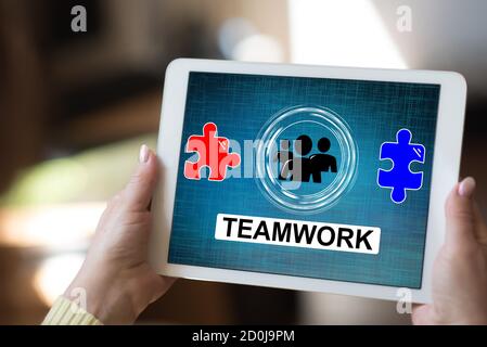 Tablet screen displaying a teamwork concept Stock Photo