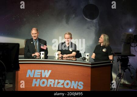 NASA Principal Investigator for New Horizons mission Alan Stern (C) is joined by Associate Administrator John Grunsfeld (L) and Mission Operations Manager Alice Bowman for a news conference as the spacecraft New Horizons approaches a flyby of Pluto, at NASA's Johns Hopkins Applied Physics Laboratory in Laurel, Maryland, July 14, 2015. More than nine years after its launch, a U.S. spacecraft sailed past Pluto on Tuesday, capping a 3 billion mile (4.88 billion km) journey to the solar system’s farthest reaches, NASA said. The craft flew by the distant 'dwarf' planet at 7:49 a.m. after reaching a