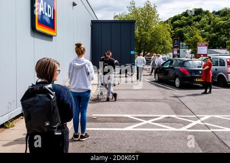 Local People Queue To Enter A Supermarket During The Corona Virus Pandemic, Lewes, East Sussex, UK. Stock Photo
