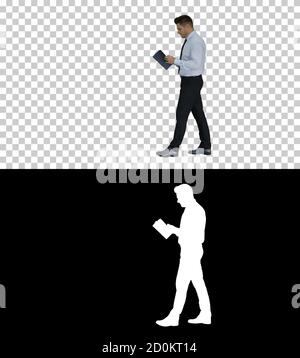 Young confused man trying to read smart book misunderstanding co Stock Photo