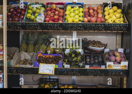 View of different fresh fruits displayed on crates in a greengrocer Stock Photo