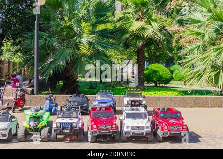 Sochi, Russia - September 07, 2019: Parked children electic cars for rent in a city park. Stock Photo