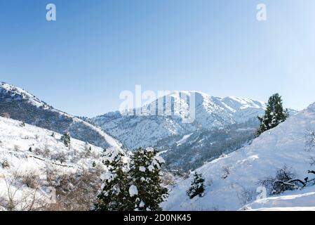 Mountain peaks of the Tien Shan covered with snow. Beldersay resort in winter on a clear Sunny day Stock Photo