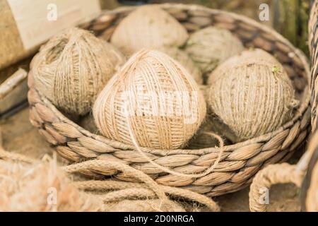 many skeins in a basket made of hemp. Fiber production. Stock Photo