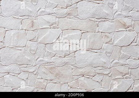 wallpaper of white stone blocks with relief and brown details Stock Photo