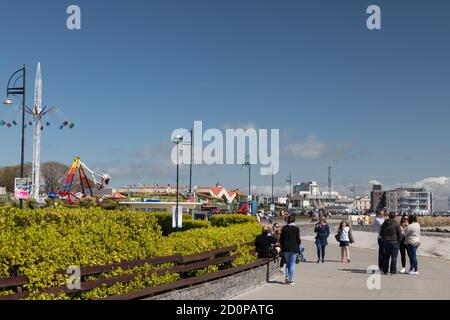 GALWAY CITY, IRELAND - 5th May, 2018: People walking on Salthill promenade on  the beach in Galway city on a sunny spring afternoon Stock Photo