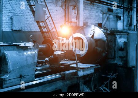 Working green lathe in the metalworking workshop toned, light effect Stock Photo