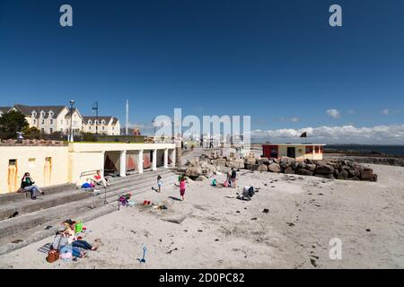 GALWAY CITY, IRELAND - 5th May, 2018: People relaxing on the beach in Salthill, Galway city Stock Photo