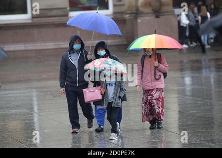 People with umbrellas in Nottingham city centre, as heavy rain is lashing parts of the UK, with the Met Office issuing warnings not seen since March. Stock Photo