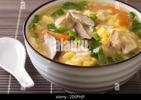 Japanese food, rice and hot pot soup calls Zosui close-up in a bowl on the table. Horizontal Stock Photo