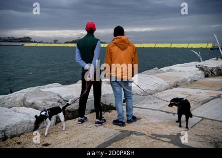 Venice, Italy - 3 October 2020: People look on at the Mose flood barriers that are deployed today for the first time leaving the city of Venice dry during high tide Credit: Piero Cruciatti/Alamy Live News Credit: Piero Cruciatti/Alamy Live News Stock Photo