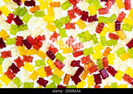 Heap of various multicolored gummy bears candies isolated on a white background Stock Photo