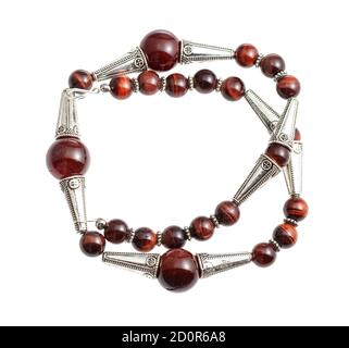 handcrafted necklace from brown agate and ox's eye beads and silver inserts isolated on white background Stock Photo
