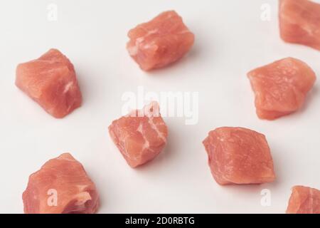 Close-up on freshly cut pork cubes on white background Stock Photo