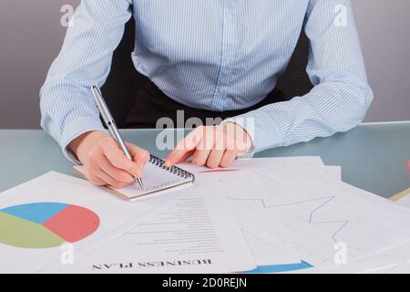 Close up business woman writing on notepad with a pen. Stock Photo