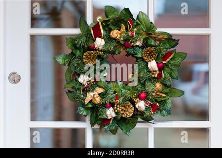 Closeup, detail of a Christmas wreath on traditional front door of a home in UK Stock Photo