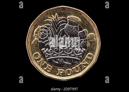 New one pound British coin of England UK introduced in 2017 which show emblems of each of the nations cut out and isolated on a black background stock Stock Photo