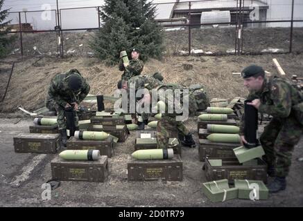 10th January 1996 During the war in Bosnia: British soldiers of the Queen’s Royal Hussars unpack 120mm smoke-bomb tank ammunition at their base in Kupres. Stock Photo