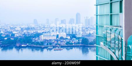 Bangkok skyline and Chao Phraya River in the morning, wideness view from balcony of room on high-rise modern glass residential building. Stock Photo