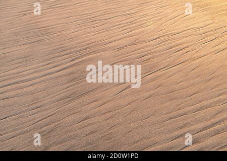 Patterns in beach sand caused by wave action Stock Photo