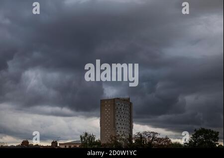 Merton, London, UK. 3 October 2020. After a night of torrential rain in London caused by Storm Alex, a brief respite before thick clouds build up, forming a dramatic backdrop to London Borough of Merton Civic Centre building with more prolonged heavy rain due on 4th October. Credit: Malcolm Park/Alamy Live News. Stock Photo