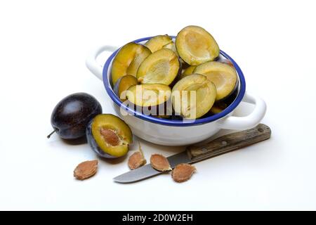Halved plums in bowl, plums, Germany, Europe Stock Photo