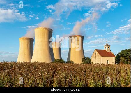 Old abandoned chapel and cooling towers of Dukovany Nuclear Power Station, Czech Republic, Europe Stock Photo