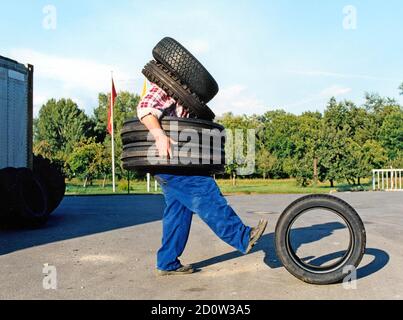 Man wearing car tires, 2015, Germany, Europe Stock Photo