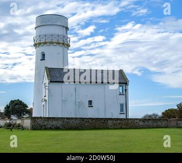 The old lighthouse on the cliffs overlooking Hunstanton beach ob the North Norfolk coast. This is no longer used as a lighthouse and has been converted in to accommodation for tourists. Stock Photo