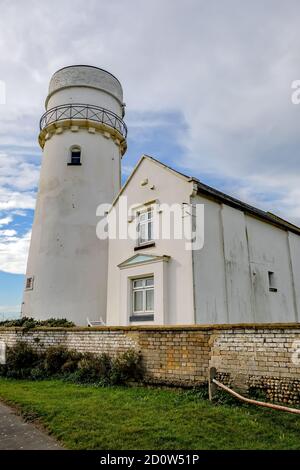 The old lighthouse on the cliffs overlooking Hunstanton beach ob the North Norfolk coast. This is no longer used as a lighthouse and has been converted in to accommodation for tourists. Stock Photo