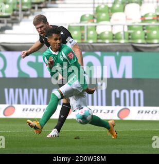 Bremen, Germany. 03rd Oct, 2020. Football: Bundesliga, Werder Bremen - Arminia Bielefeld, 3rd matchday. Werder's Theodor Gebre Selassie (in front) cannot prevent Bielefeld's Fabian Klos from taking the shot. Credit: Carmen Jaspersen/dpa - IMPORTANT NOTE: In accordance with the regulations of the DFL Deutsche Fußball Liga and the DFB Deutscher Fußball-Bund, it is prohibited to exploit or have exploited in the stadium and/or from the game taken photographs in the form of sequence images and/or video-like photo series./dpa/Alamy Live News Stock Photo