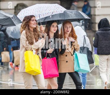 People with umbrellas in Nottingham city centre, as heavy rain is lashing parts of the UK, with the Met Office issuing warnings not seen since March, as winds of up to 65mph are expected along the coast on Saturday along with heavy rain as Storm Alex hits the UK. Stock Photo