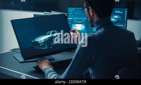 Professional Automotive Graphic Designer is Working on Concept Car Render with a Stylus Pen in a High Tech Innovative Laboratory with a Prototype Car Stock Photo