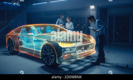 Group of Automobile Design Engineers Working in Virtual Reality 3D Model Prototype of Electric Car Chassis. Automotive Innovation Facility: 3D Concept Stock Photo