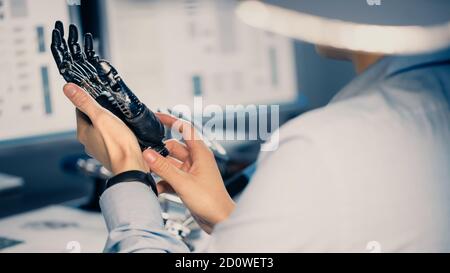 Close Up of a Futuristic Prosthetic Robot Arm Being Tested by a Professional Development Engineer in a High Tech Research Laboratory with Modern Stock Photo