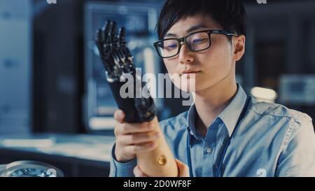 Close Up of a Futuristic Prosthetic Robot Arm Being Tested by a Professional Japanese Development Engineer in a High Tech Research Laboratory with