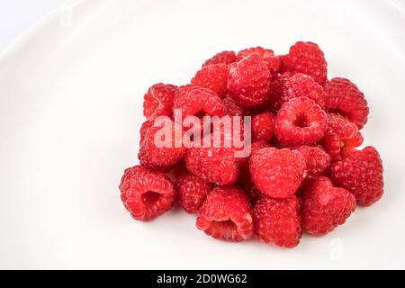 Fresh, juicy raspberries with water drops close-up. Stock Photo