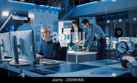 Diverse International Team of Industrial Engineers and Scientists Working in Research Laboratory and Development Center. People Working with 3D Stock Photo
