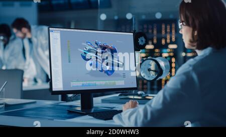 Over the Shoulder Shot: Female IT Scientist Uses Computer Showing CAD Software with Airplane Engine. In the Background Technology Development Stock Photo